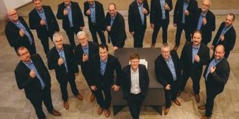 18 Männer in dunklen Anzügen